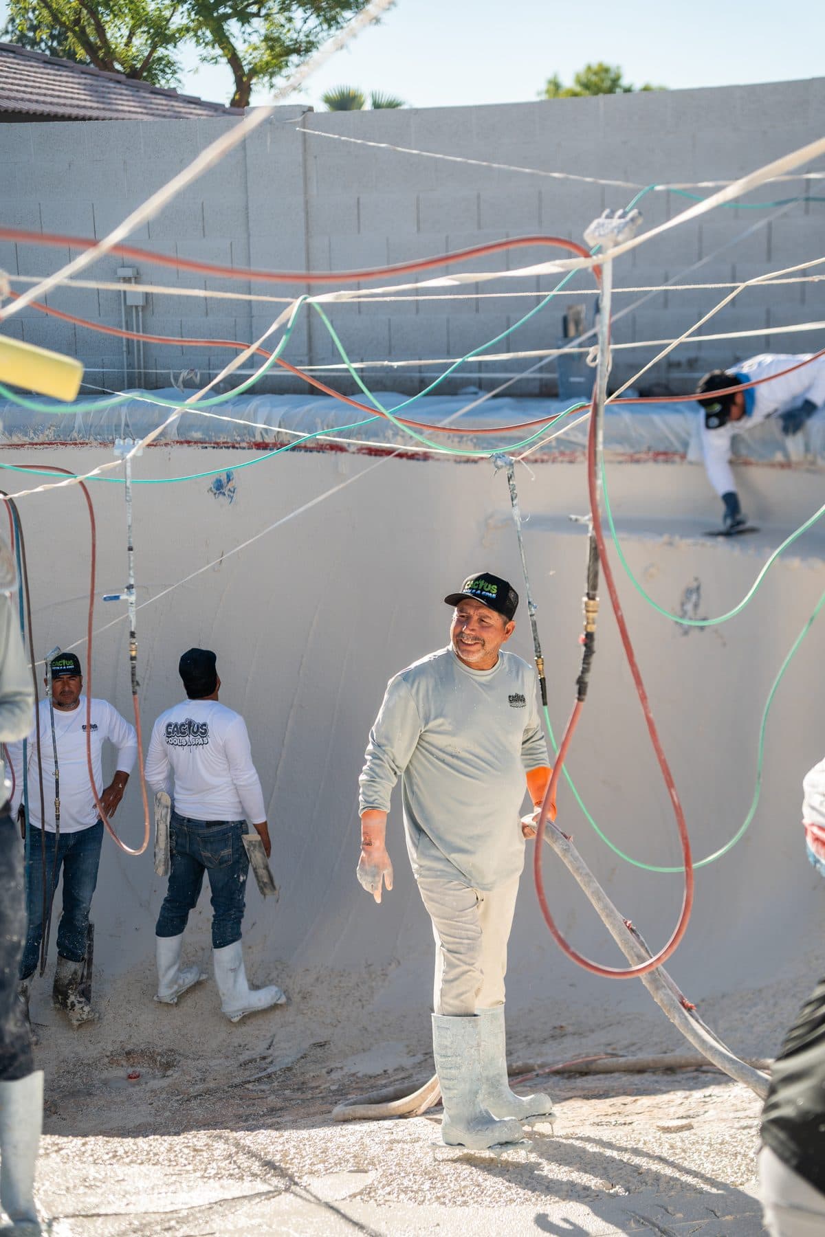 The Cactus crew at work inside a pool during a resurfacing job
