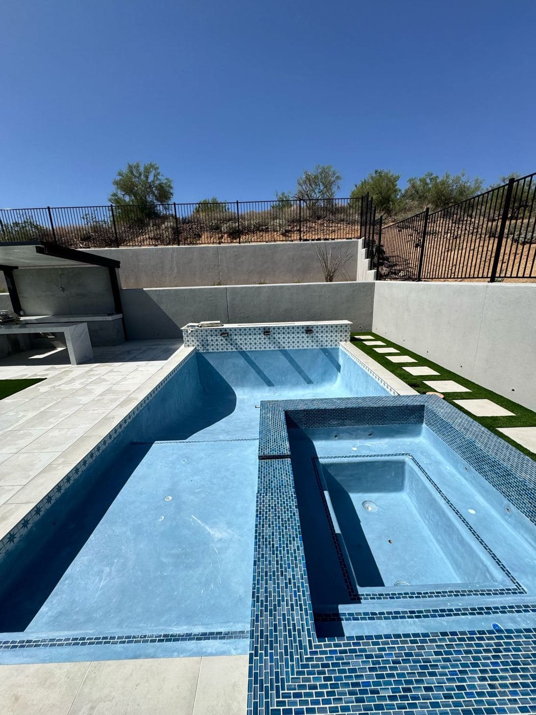 New pool and raised spa with blue glass tile